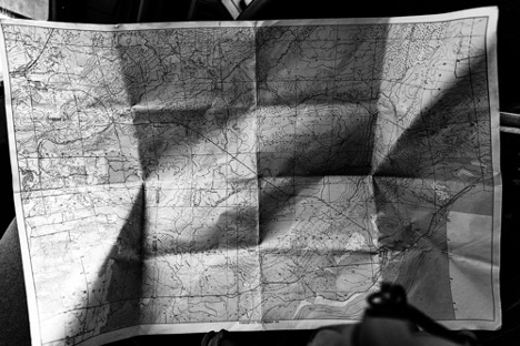 A photo of an old map in black and white and greenish tones. The map has may creases on it and looks like it has been used many times before. An early investor in ShotSpotter, Gary Lauder, was a map collector.