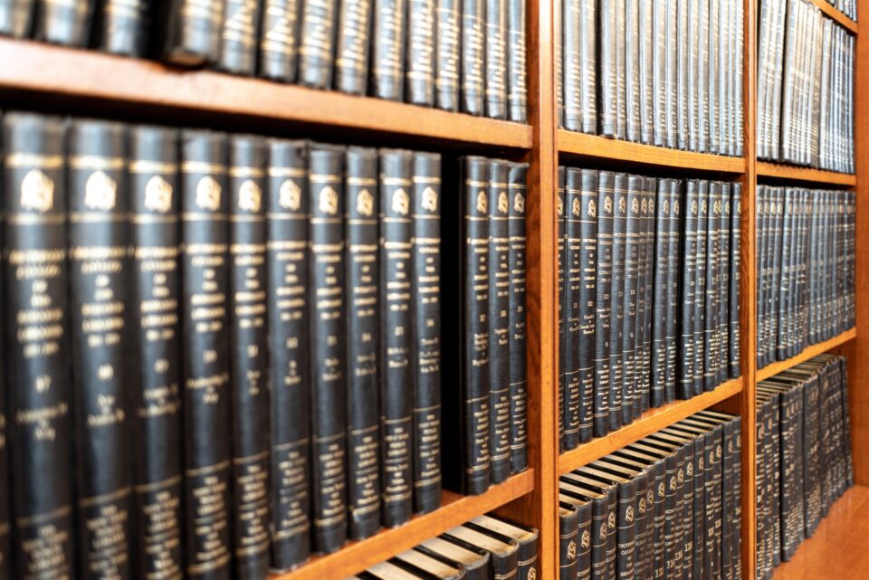 A bookshelf of legal casebooks in a law library.