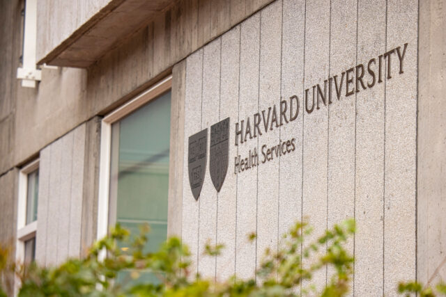 The sign for Harvard University Health Service’s Center on the exterior of its building[