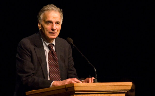 Ralph Nader speaking from a podium with black background. 