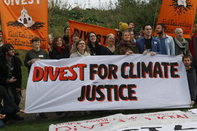 A group of people at a gathering in 2016 supporting fossil fuel divestment. 