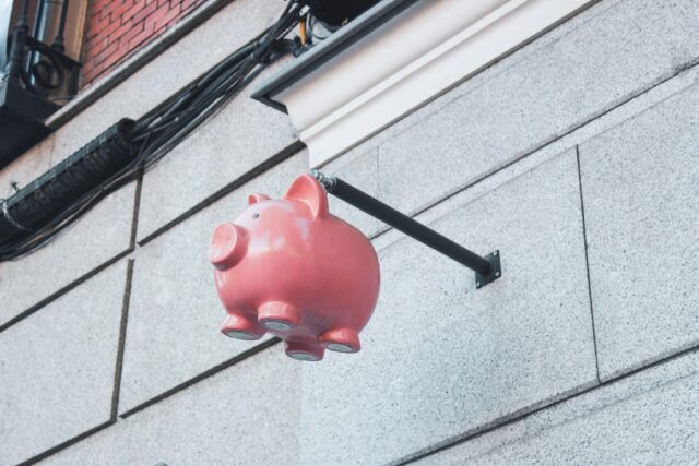 A piggy bank suspended in the air.