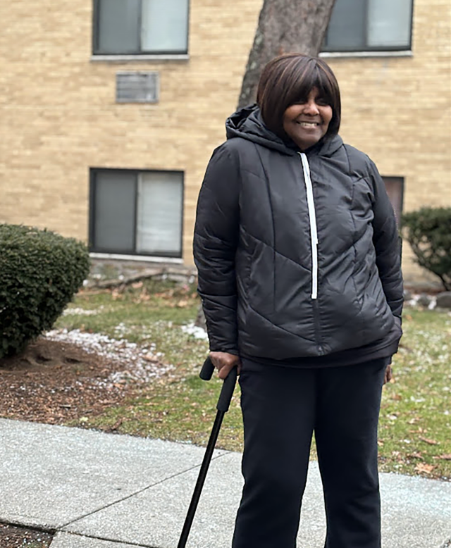 Betty Lewis standing outside the Fairlawn Apartment complex.