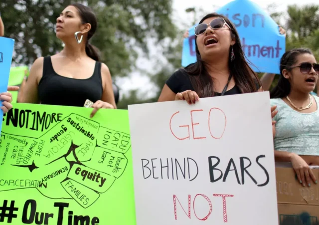 Protesters gathered in front of the GEO Group headquarters protesting their private prisons on May 4, 2015, in Boca Raton, Florida. 