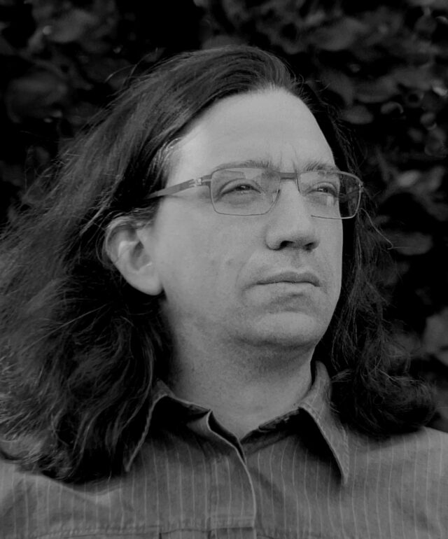 Black and white headshot of Curtis Yarvin