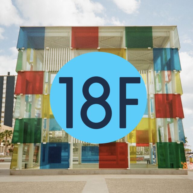 The former 18F government agency logo is overlaid on top of a film photograph of a giant multi-colored cubic sculpture.