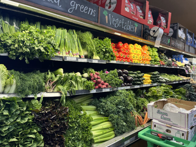 A photo shows a shelf of fresh vegetables 