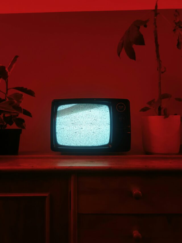 Photo of an old TV with no signal against a red background