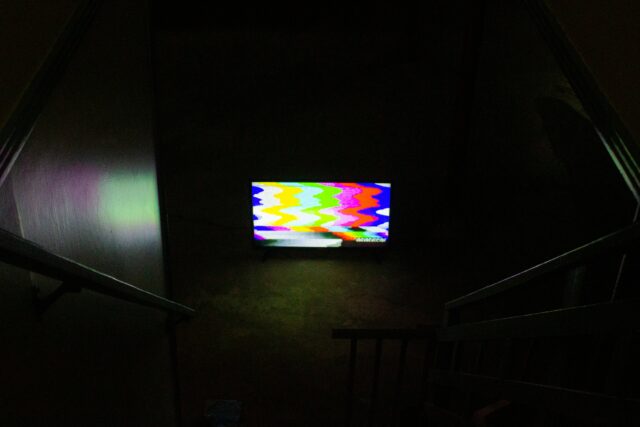 Photo of a computer at the bottom of a set of stairs.