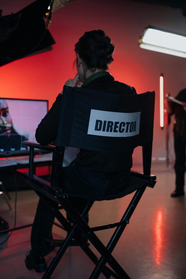 Photo of a seated director watching footage.