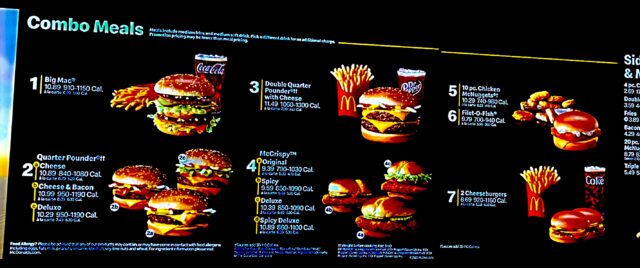Digital McDonald’s “Combo Meals” menu board showing seven numbered meal options—burgers, nuggets, fries, and drinks—with prices and calorie ranges.