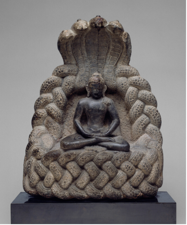 A stone sculpture of a deity sitting cross-legged and surrounded by cobras whose tails are braided together around the deity and whose serpentine heads face forward above the deity’s head. The Art Institute of Chicago titles the statue “Buddha Sheltered by the Serpent King Muchalinda.”