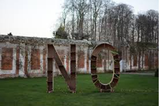A sculpture of the words “NO” on a field.