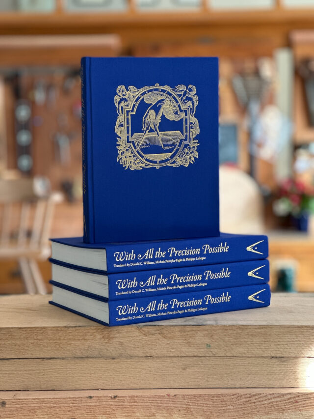 A stack of three blue books with another book on top.