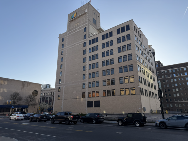 Perspective shot of the RG&E building rising into the Rochester sky with Avangrid’s logo mounted prominently at the top.